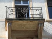 Un balcon, avec l'ébauche de lignes serpentines dans la ferronnerie